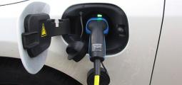 a charger is plugged into an electric vehicle